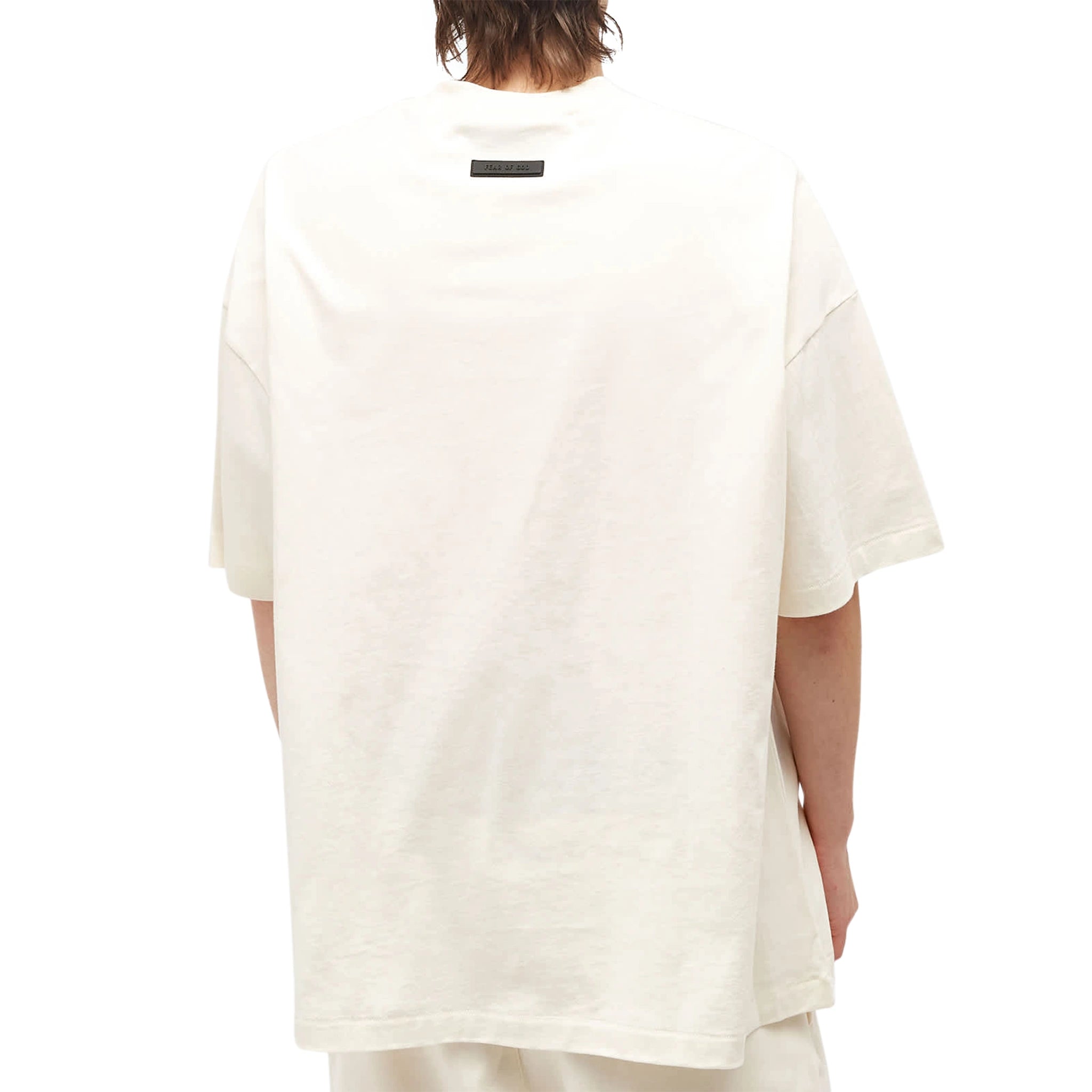 Model back view of Fear Of God Essentials Cloud Dancer T Shirt (FW23)